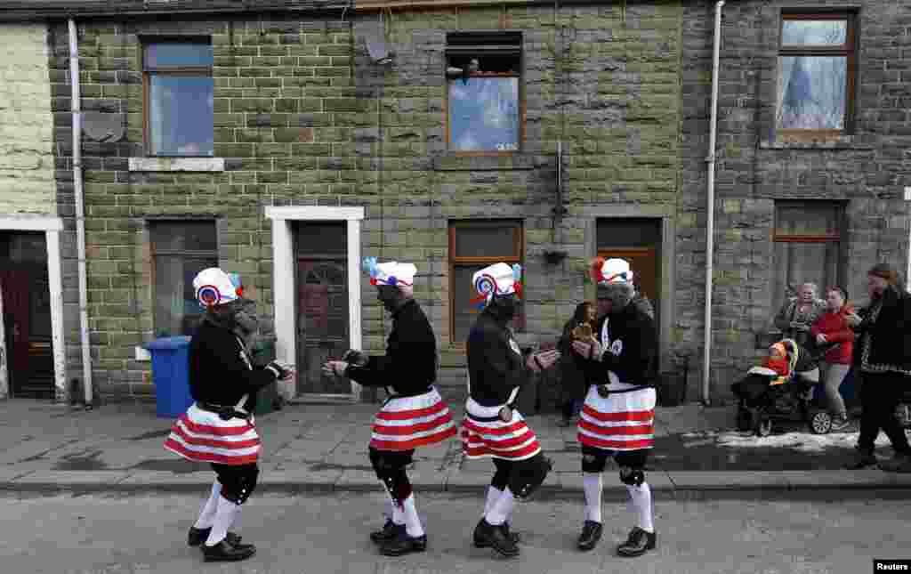 Members of the Britannia Coconut dancers perform on the roadside near Bacup, northern England. The group, which can trace its origins to the mid-1800s, dance along the town's roads every Easter Saturday following a tradition to mark out the boundaries of the town.
