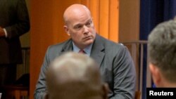 FILE - Matthew Whitaker attends a roundtable discussion at the Justice Department in Washington, Aug. 29, 2018.