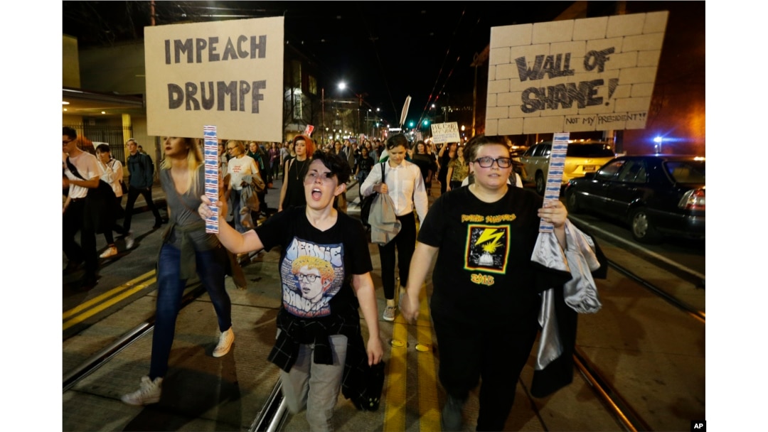 Protesters call for the impeachment of President-elect Donald Trump as they march in Seattle, Nov. 9, 2016.