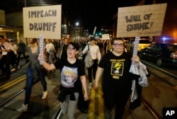 Protesters call for the impeachment of President-elect Donald Trump as they march in Seattle, Nov. 9, 2016.