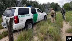 n this Sept. 5, 2014 photo, a U.S. Customs and Border Protection Air and Marine agents and U.S. Customs and Border Protection agents compare notes as they patrol near the Texas-Mexico border, near McAllen, Texas. (AP Photo/Eric Gay)