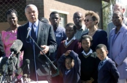 FILE - U.S. Secretary of State Colin Powell addresses members of the media after he meets victims of HIV/AIDS at the Jabavu Clinic in Soweto west of Johannesburg, May 25, 2001.