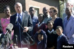 FILE - U.S. Secretary of State Colin Powell addresses members of the media after he meets victims of HIV/AIDS at the Jabavu Clinic in Soweto west of Johannesburg, May 25, 2001.