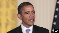 President Barack Obama gestures during his joint news conference with South Korean President Lee Myung-bak, in the East Room at the White House in Washington, October 13, 2011.