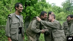 Kurdish fighters from the Kurdistan Workers Party (PKK) congratulate each other after arriving in the Heror area, northeast of Dahuk, 260 miles (430 kilometers) northwest of Baghdad, May 14, 2013. 