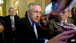 Senate Majority Leader Sen. Harry Reid is surrounded by reporters after leaving the office of Senate Minority Leader Sen. Mitch McConnell on Capitol Hill, Oct. 14, 2013.