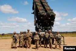 U.S. soldiers stand next to the Patriot, a long-range air defense system, during an air defense exercise near Siauliai, Lithuania, July 20, 2017.