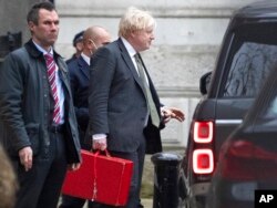 Britain's Prime Minister Boris Johnson leaves Downing Street in London, Dec. 17, 2021.