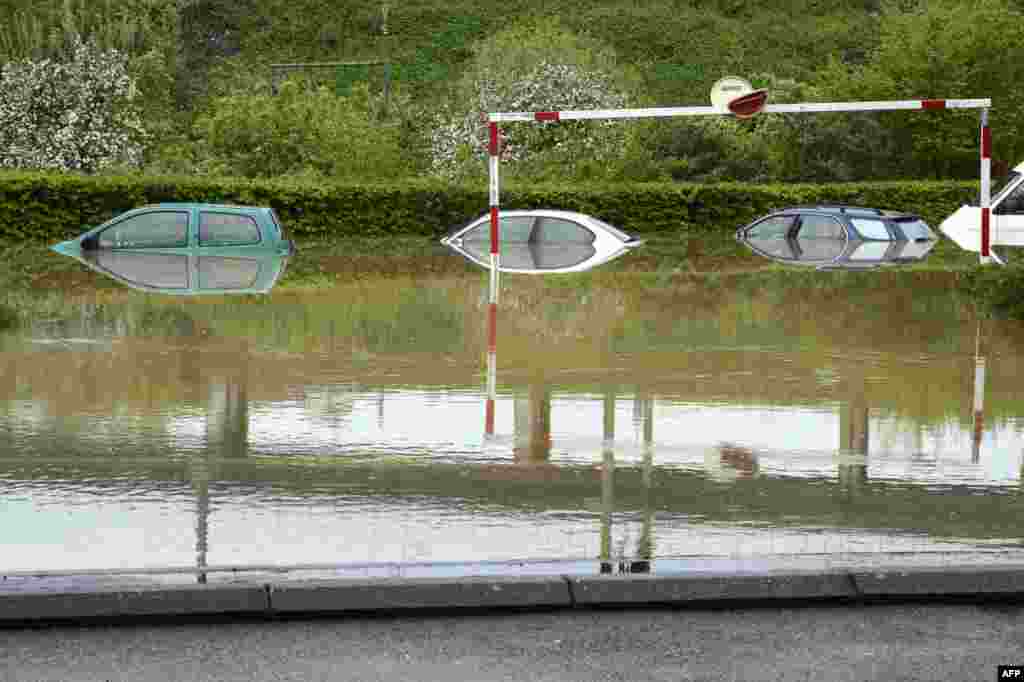 Cars are seen on a flooded parking lot after the overflowing of the Ouche river caused by recent heavy rainfalls in Dijon, central eastern France.
