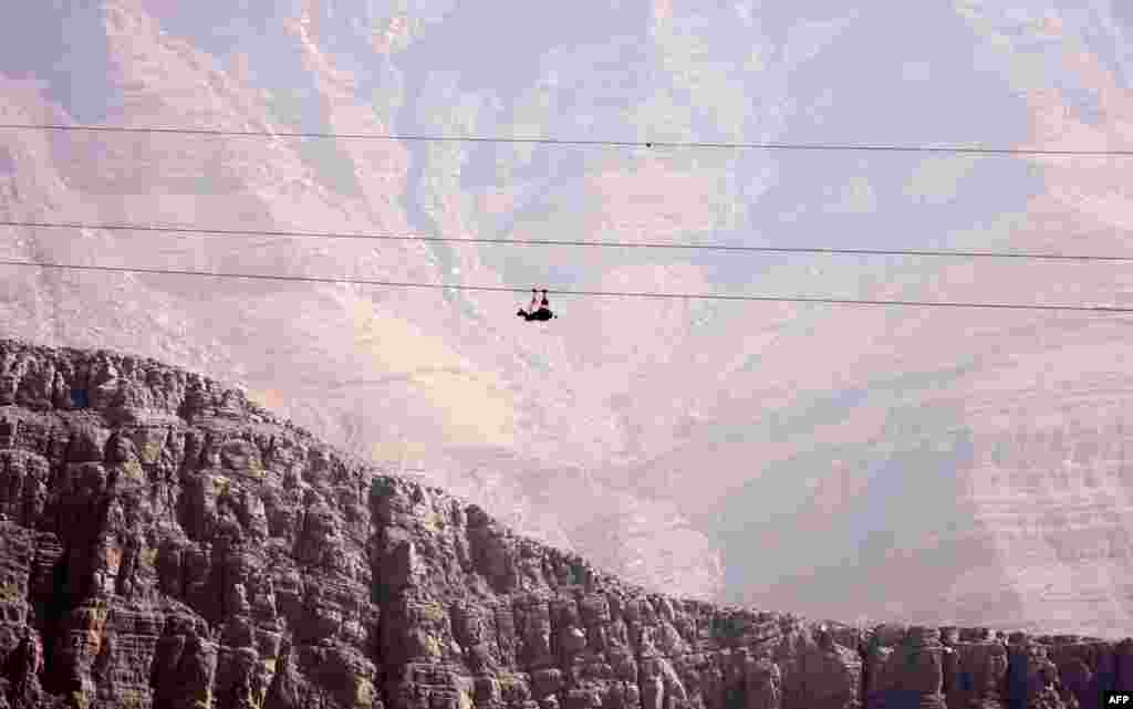 A man practices rope-sliding in the mountain range of Jabel Jais, in the Gulf Emirate of Ras Al Khaimah, Jan. 24, 2021.