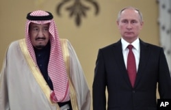 Russian President Vladimir Putin, right, and Saudi Arabia's King Salman pose for a photo during a welcoming ceremony ahead of their talks at the Kremlin in Moscow, Russia, Oct. 5, 2017.