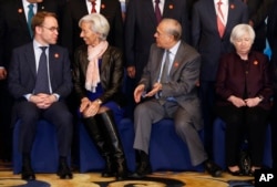 From left, Germany's Federal Bundesbank Jens Weidmann, IMF Managing Director Christine Lagarde, OECD Secretary-General Jose Angel Gurria and U.S. Federal Reserve Board Chair Janet Yellen take their seats for a family photo of G20 Finance Ministers and Central Bank Governors Meeting at the Pudong Shangri-la Hotel in Shanghai, Feb. 27, 2016.