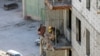 FILE- North Korean workers at a construction site in the capital Ulaanbaatar on October 6, 2017. 