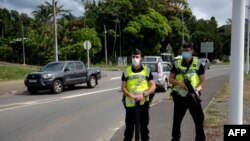 Gendarmes secure the road of Saint Michel, on the day of the vote for the referendum on independence, in Mont Dore, on the French South Pacific territory of New Caledonia on Dec. 12, 2021.