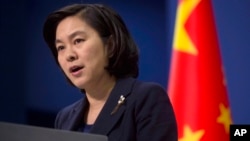 FILE - Chinese Foreign Ministry spokeswoman Hua Chunying speaks during a briefing at the Chinese Foreign Ministry in Beijing.