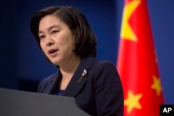 FILE - Chinese Foreign Ministry spokeswoman Hua Chunying speaks during a briefing at the Chinese Foreign Ministry in Beijing.