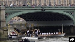 The royal barge Gloriana carries the Olympic flame along the river Thames, on the final day of the Torch Relay, London, July 27, 2012. 