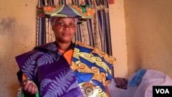 Charlotte Mapendo fled the DRC two years ago, and now supports her family by selling kitenge cloth door to door. June 24, 2014. (Hilary Heuler / VOA News)