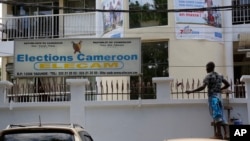 Un homme peint le bureau de la commission électorale à Yaoundé, au Cameroun, le 10 octobre 2018. 