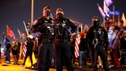 North Las Vegas Police officers keep an eye on supporters of U.S. President Donald Trump during a "Stop the Steal" protest at Clark County Election Center in North Las Vegas, Nevada, U.S. November 5, 2020. REUTERS/Steve Marcus