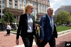 Paul Manafort's former bookkeeper Heather Washkuhn, left, walks to the Alexandria Federal Courthouse in Alexandria, Va., Aug. 2, 2018, to testify at Manafort's tax evasion and bank fraud trial.