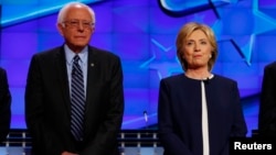 Democratic presidential candidate Senator Bernie Sanders and former Secretary of State Hillary Clinton stand together before the start of the first official Democratic candidates debate of the 2016 presidential campaign in Las Vegas, Nevada Oct. 13, 2015.