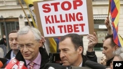 Socialist parliament member Jean-Louis Bianco, left, and Socialist's Lionel Lucas answer reporters outside the Chinese embassy in Paris, Tuesday, March 18, 2008, during a protest against the crackdown on demonstrations in Tibet by the Chinese authority, i