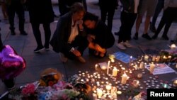 Women pay their respects to all those affected by the bomb attack, following a vigil in central Manchester, Britain, May 23, 2017. 