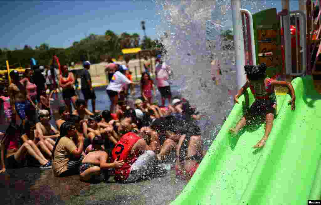 A girl enjoys the day in a public water park amid the first heatwave of the summer season in Buenos Aires, Argentina.