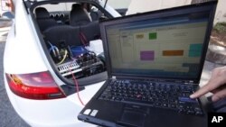 In this photo taken April 1, 2010, Stanford graduate student Mick Kritayakirana uses a laptop computer as he demonstrates the computer system inside a driverless car on the Stanford University campus in Palo Alto, Calif. The car, named Shelley, is the lat