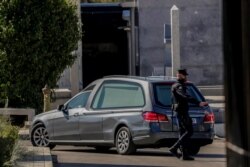 A hearse carrying the remains of late dictator Gen. Francisco Franco arrives for reburial at Mingorrubio's cemetery, on the outskirts of Madrid, Spain, Oct. 24, 2019.