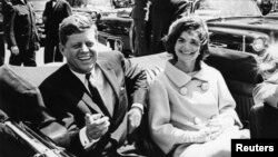 FILE - Former United States President John F. Kennedy and first lady Jackie Kennedy sit in a car in front of Blair House, May 3, 1961.