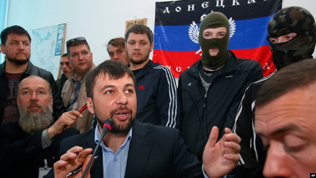 Denis Pushilin, foreground center, spokesman of the self-appointed Donetsk People’s Republic, speaks to reporters inside the regional administration building seized earlier in Donetsk, Ukraine, April 18, 2014. 