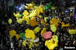 FILE - Protesters hold inflatable toys during a pro-democracy rally demanding that the prime minister resign, in Bangkok, Thailand, Nov. 27, 2020.