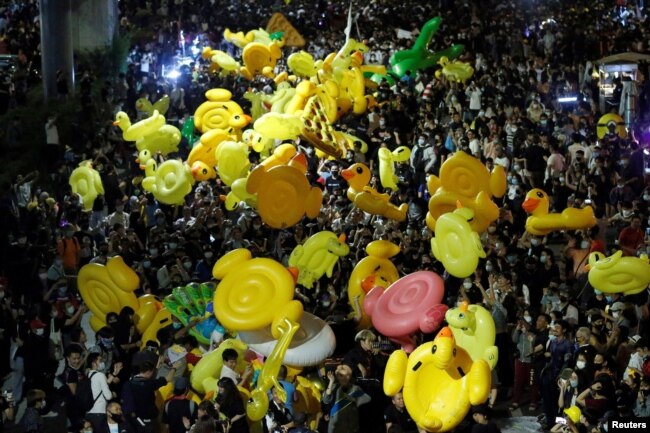 FILE - Protesters hold inflatable toys during a pro-democracy rally demanding that the prime minister resign, in Bangkok, Thailand, Nov. 27, 2020.