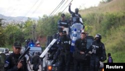 Members of the Honduran police arrive at their headquarters to take part in a strike to demand higher wages and rest after working extra hours due to protests caused by the delay in vote counting in the general election, in Tegucigalpa, Honduras, Dec. 4, 