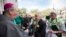 FILE - In this March 16, 2019 photo, Bishop Gregory J. Hartmayer, left, at the St. Patrick's Day parade in Savannah, Ga. He will be installed as Atlanta's new archbishop in a socially-distant Mass.