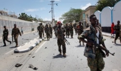 FILE - Somali government soldiers patrol following a blast near the presidential palace in the capital Mogadishu, Somalia, Aug. 30, 2016.