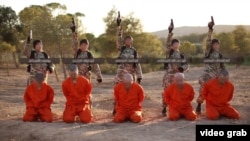 A screen shot from an Islamic State propaganda video purports to show young boys executing a group of captives.