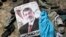 A poster of deposed Egyptian president Mohamed Morsi lies amid debris in a cleared protest camp of his supporters in Cairo August 15, 2013.