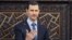 In this photo released by the Syrian official news agency SANA, shows Syrian President Bashar Assad, as he delivers a speech at the parliament in Damascus, June 3, 2012.