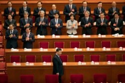 FILE - Chinese President Xi Jinping arrives for the closing session of the National People's Congress in Beijing's Great Hall of the People, March 15, 2019.