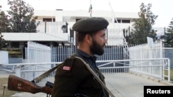 FILE - A Pakistani soldier stands guard in front of the Indian High Commission in Islamabad, Feb. 8, 2003. 