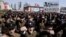 University students punch the air as they march through Kim Il Sung Square in downtown Pyongyang, North Korea, March 29, 2013. 