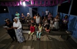 Worshippers attend a prayer ceremony known as the "celebration of the word" led by Antelmo Pereira at the Catholic church in Santa Rosa, Brazil, Sept. 21, 2019.