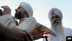 FILE - People gather in Lafayette near the White House, Aug. 8, 2012 to participate in a candlelight vigil against hate violence after a shooting at a Sikh temple in Wisconsin.