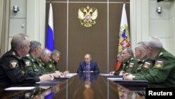 Russian President Vladimir Putin, center, chairs a meeting on the defense industry at the Bocharov Ruchei state residence in Sochi, Russia, Nov. 10, 2015. 