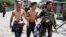 Government soldiers escort residents who were taken hostage and used as human shields by Muslim rebels of Moro National Liberation Front (MNLF) during fighting with government soldiers, in Zamboanga city in southern Philippines, Sept. 17, 2013. 