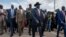 South Sudan's President Salva Kiir, center, arrives back in the country from peace talks in Addis Ababa, at the airport in Juba, South Sudan, June 22, 2018.