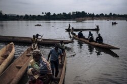 FILE - Central African refugees arrive in Ndu after crossing the Mbomou River, which marks the border between the Central African Republic and the Democratic Republic of Congo, Feb. 5, 2021.